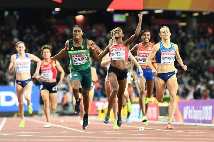 Kenya's Faith Chepngetich Kipyegon celebrates winning as South Africa's Caster Semenya grabs third in the final of the 1,500m event, at the 2017 IAAF World Championships in London on August 7