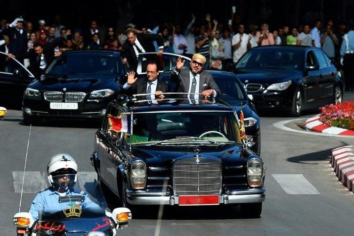 In this archive picture, Morocco's King Mohammed VI (right) and French President Francois Hollande wave to the crowds from their car on September 19, 2015 in the Moroccan port city of Tangier AFP PHOTO / POOL / ALAIN JOCARD