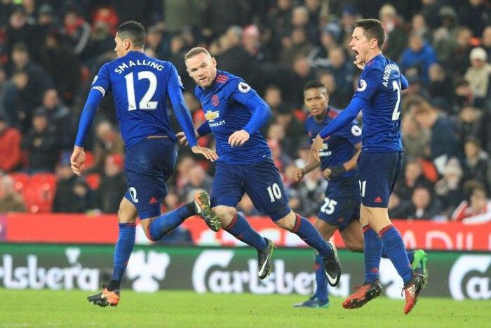 Manchester United's striker Wayne Rooney (C) celebrates scoring the equalising goal against Stoke City on January 21, 2017