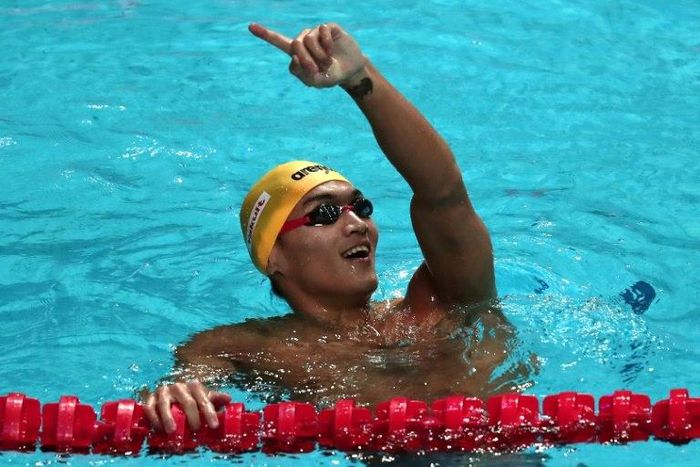 China's Xu Jiayu reacts after winning in the men's 100m backstroke final on July 25, 2017