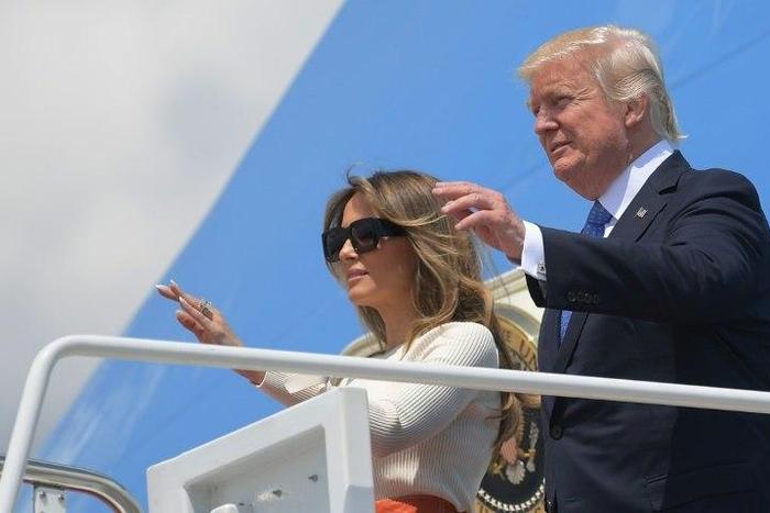 Donald Trump and his wife Melania wave before boarding Air Force One for his first trip abroad as US president