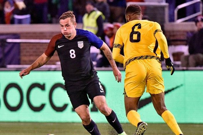 Jordan Morris (L) of the US fights for the ball with Sergio Campbell of Jamaica during the first half of their friendly match, at Finley Stadium in Chattanooga, Tennessee, on February 3, 2017