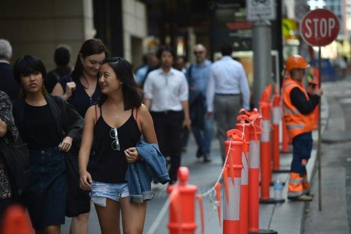 Pedestrians in Sydney's central business district on April 19, 2017. Australia's decision to scrap a visa programme for temporary foreign workers won both praise and criticism