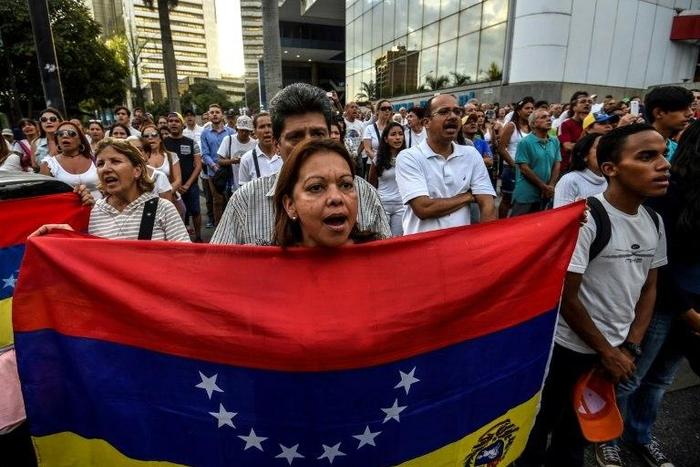 Venezuelan opposition activists march during a protest against President Nicolas Maduro's government, in Caracas on April 15, 2017