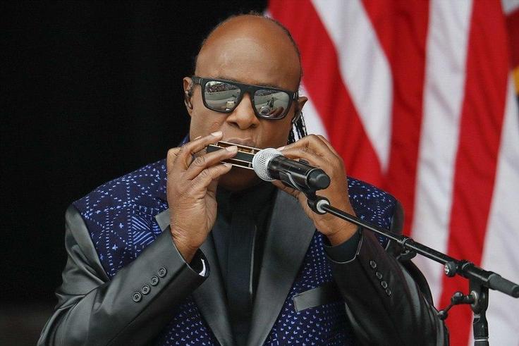 Stevie Wonder playing his harmonica before Obama's speech