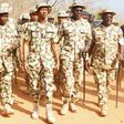 Chief Of Army Staff (COAS), Lt. Gen. Tukur Buratai flanked by troops.