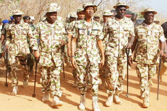 Chief Of Army Staff (COAS), Lt. Gen. Tukur Buratai flanked by troops.