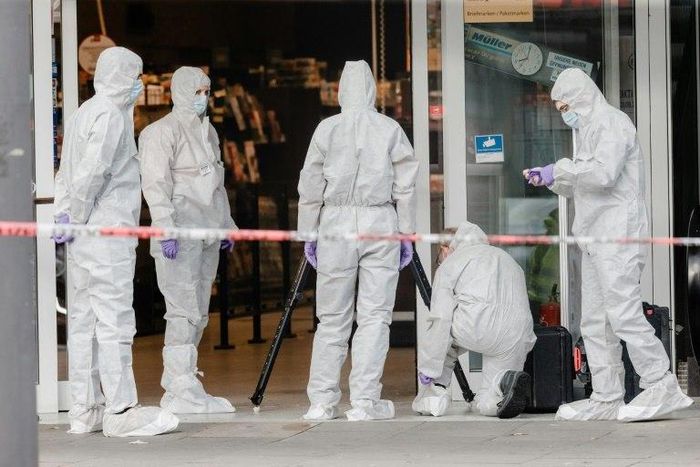 Police investigator work at the area around a supermarket in the northern German city of Hamburg, where a man killed one person in a knife attack, on July 28, 2017