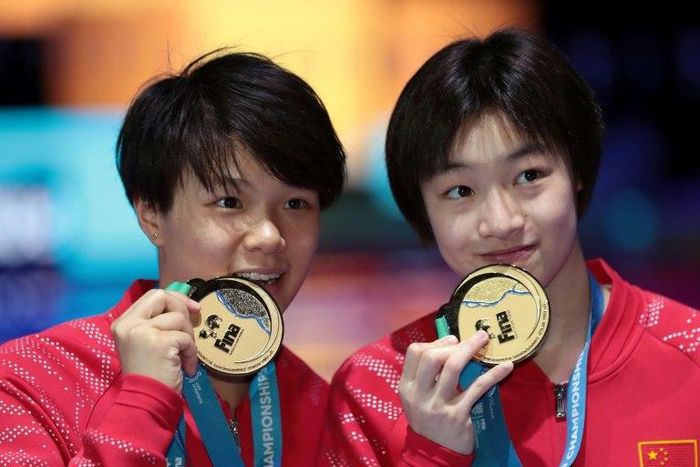 China's Chang Yani and Shi Tingmao pose with their gold medal for the women's 3m springboard synchro final during the diving competition at the 2017 FINA World Championships in Budapest, on July 17, 2017