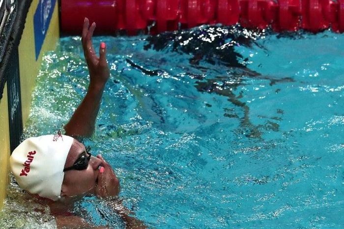 Canada's Kylie Masse celebrates a new world record after the women's 100m backstroke final on July 25, 2017