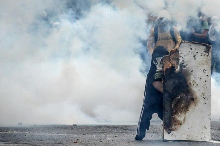 Demonstrators clash with riot police in the latest of a series of violent protests over the economic crisis gripping Venezuela