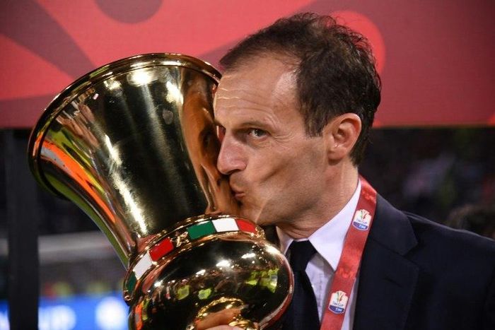 Juventus' coach from Italy Massimiliano Allegri kisses the trophy after winning the Italian Tim Cup final on May 17, 2017 at the Olympic stadium in Rome
