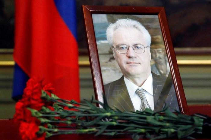 Flowers are laid in front of a portrait of Russia's Ambassador to the United Nations Vitaly Churkin at the Foreign Ministry guest house in Moscow on February 21, 2017