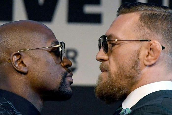 Boxer Floyd Mayweather Jr. (L) and UFC lightweight champion Conor McGregor face off during a news conference at the KA Theatre at MGM Grand Hotel & Casino on August 23, 2017 in Las Vegas, Nevada