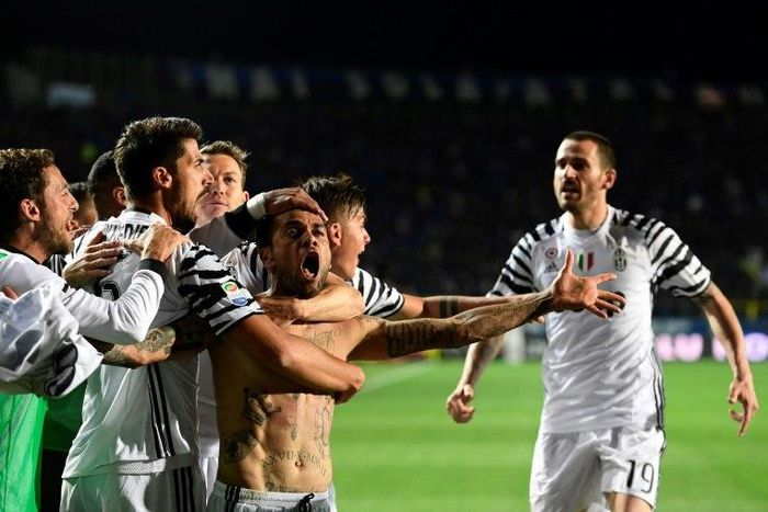 Juventus' defender Daniel Alvez da Silva celebrates with teammates after scoring during the Italian Serie A football match against Atalanta on April 28, 2017