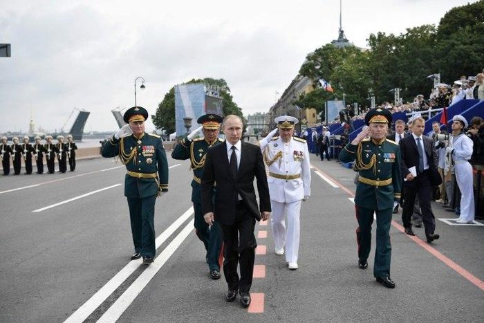 Russia's President Vladimir Putin (centre) walks with officials as he attends a ceremony for Russia's Navy Day in Saint Petersburg on July 30, 2017