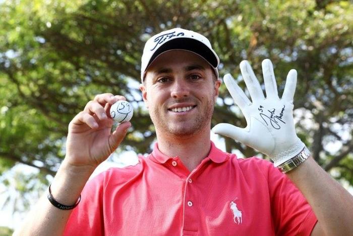 Justin Thomas of the United States celebrates after scoring a 59 during the first round of the Sony Open In Hawaii at Waialae Country Club on January 12, 2017 in Honolulu, Hawaii