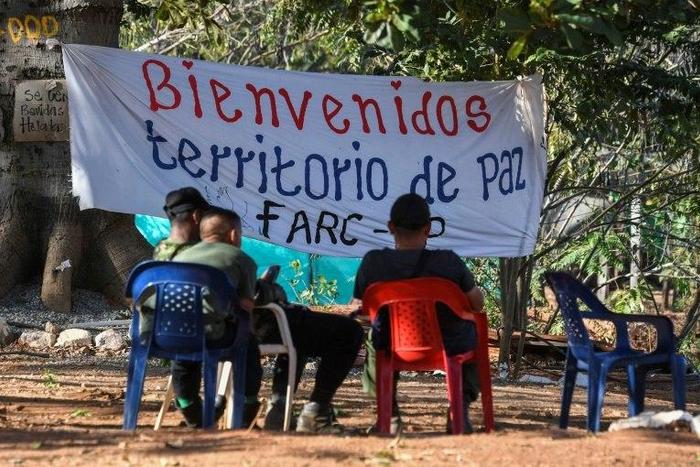 Members of the FARC leftist guerrilla rest at the entrance to the area where the rebels are gathering in the municipality of San Jose de Oriente, Cesar department, northern Colombia on February 28, 2017
