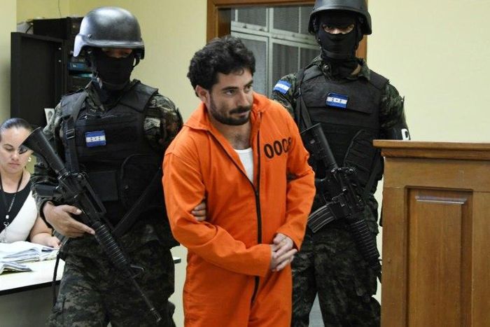 Police escort Plutarco Antonio Ruiz after he was found guilty of the 2014 murder of then Miss Honduras Maria Jose Alvarado, 19, and her sister Sofia Trinidad Alvarado, 23