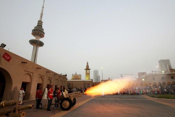 A picture taken on June 24, 2017 shows a cannon being shot at the Nayef Palace in Kuwait City signalling the end of the holy fasting month of Ramadan