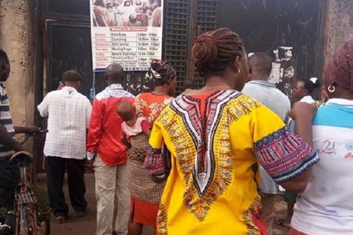 Residents trying to get a glimpse of the church where the Badoo gang attacked