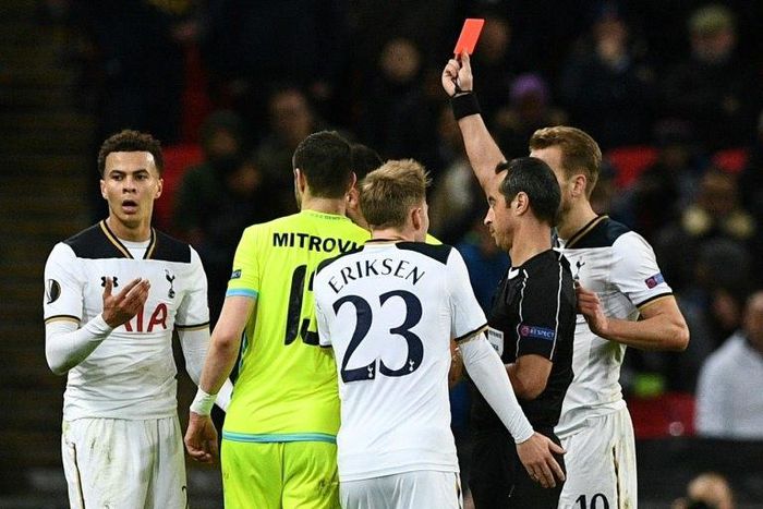 Portuguese referee Jorge Sousa shows a straight red card to Tottenham Hotspur's Dele Alli (left) during their Europa League match against Gent at Wembley Stadium in north London, on February 23, 2017