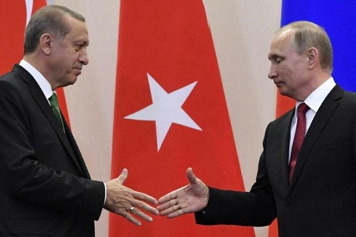 Russian President Vladimir Putin (R) shakes hands with his Turkish counterpart Recep Tayyip Erdogan after a joint press conference following their meeting at the Bocharov Ruchei state residence in Sochi on May 3, 2017