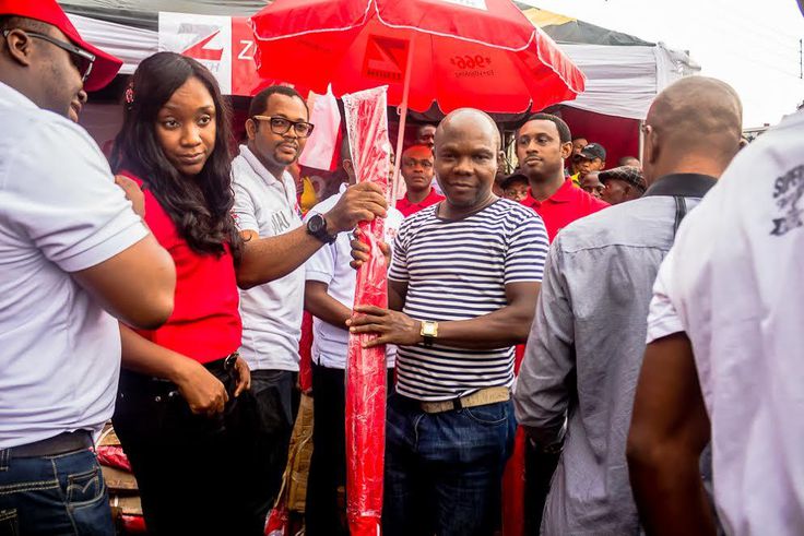 One of the beneficiaries of the programme is seen receiving an umbrella.