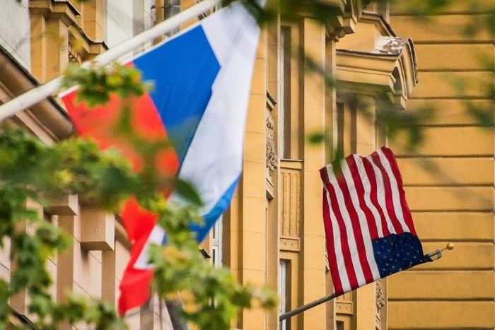 A Russian flag flies next to the US embassy building in Moscow on July 31, 2017