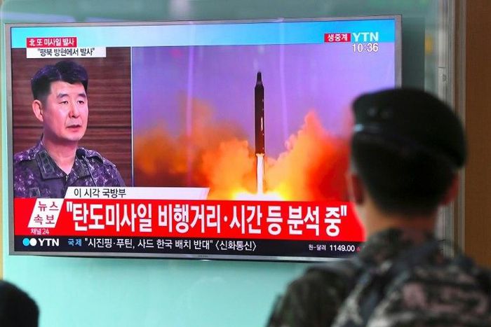 A South Korean soldier watches a television news showing file footage of a North Korean missile launch, at a railway station in Seoul on July 4, 2017