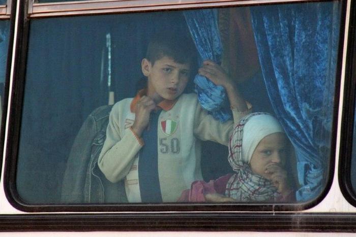 Syrian civilians being evacuated from the government-held towns of Fuaa and Kafraya, which have been under crippling siege for more than two years, on buses near the rebel-held transit point of Rashidin on April 19, 2017