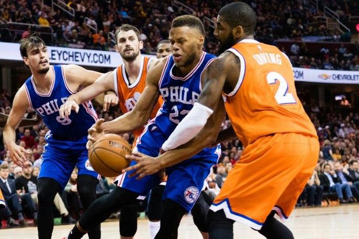 Richaun Holmes of the Philadelphia 76ers tries to drive around Kyrie Irving of the Cleveland Cavaliers during the first half at Quicken Loans Arena
