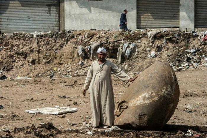 The head of a pharaonic statue that dates back over 3,000 years found in a muddy pit of what is now a sprawling Cairo suburb