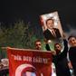 A supporter of the "Yes" campaign holds up a picture of Turkish president Recep Tayyip Erdogan during a rally near the headquarters of the conservative Justice and Development Party (AKP) in Istanbul on April 16, 2017 after initial results
