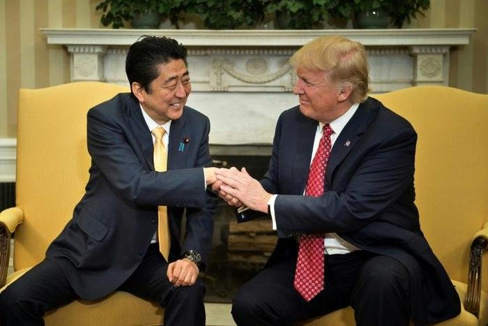 US President Donald Trump praised Japanese Prime Minister Shinzo Abe's "strong hands" after greeting him with a hug at the White House