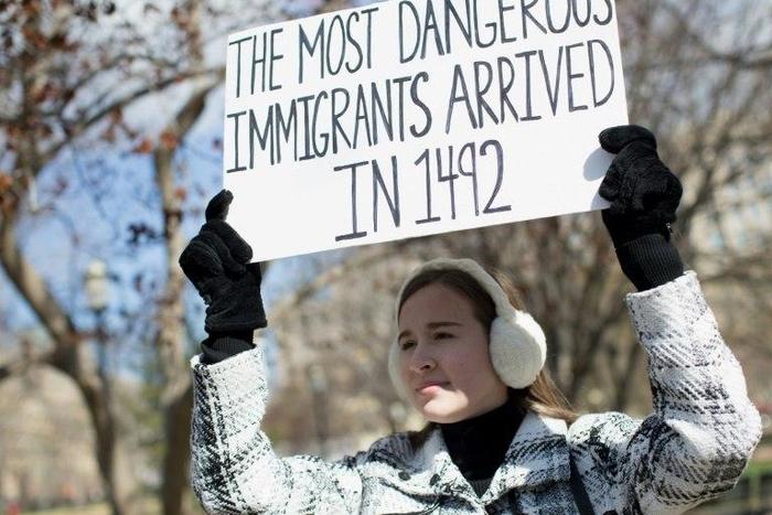A demonstrator holds a sign near the White House to protest President Donald Trump's travel ban on six Muslim countries