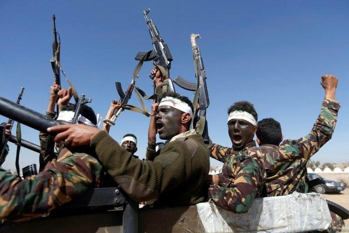 Newly recruited Houthi fighters chant slogans as they ride a military vehicle during in the Yemeni capital Sanaa on January 3, 2017