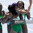 Gloria Asumnu, Blessing Okagbare, Jennifer Madu and Agnes Osazuwa of Nigeria react during round one of the Women's 4 x 100m Relay on Day 13