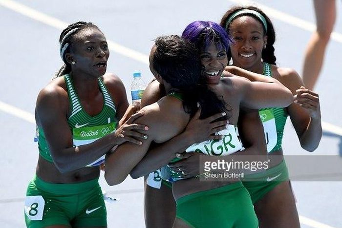 Gloria Asumnu, Blessing Okagbare, Jennifer Madu and Agnes Osazuwa of Nigeria react during round one of the Women's 4 x 100m Relay on Day 13