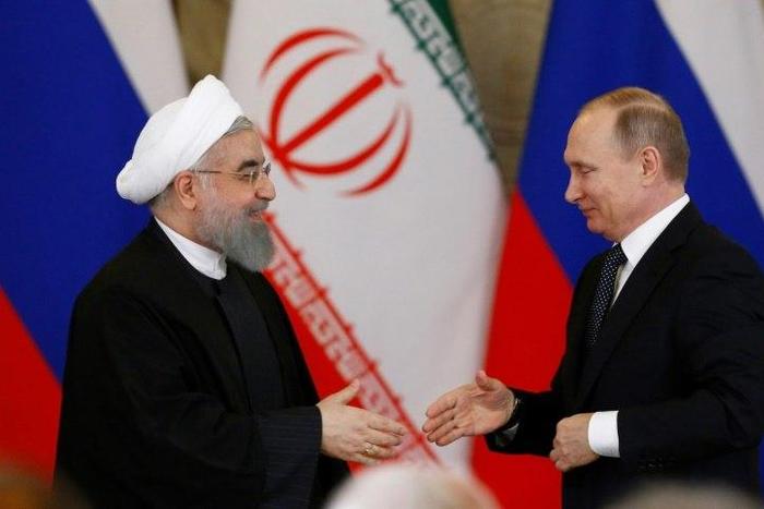 Russian President Vladimir Putin (R) shakes hands with his Iranian counterpart Hassan Rouhani during a joint press conference following their meeting at the Kremlin in Moscow on March 28, 2017