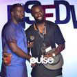 Kola Kuddus presents Hym Signage his award at NSDFW 2017
