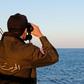 A Tunisian coast guard officer monitors the country's maritime borders during a patrol on March 30, 2017