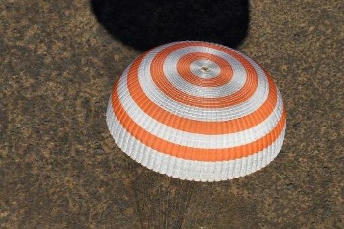 A Soyuz MS-02 capsule brings Russian cosmonauts Sergey Ryzhikov and Andrey Borisenko and US astronaut Shane Kimbrough back home after a 173-day mission to the International Space Station