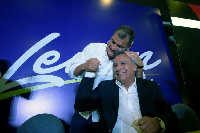 Ecuadorian President Rafael Correa (L) hugs Lenin Moreno during a post-election rally in Quito, on February 19, 2017