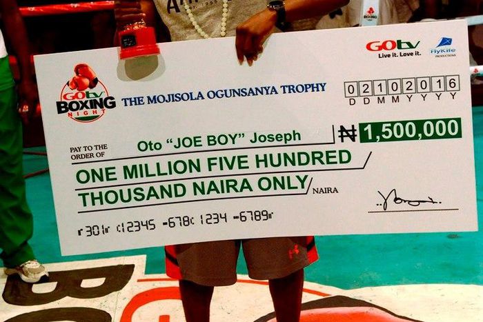 Joe Boy flaunts his trophy and cheque