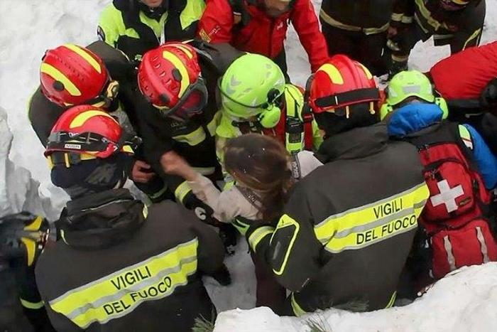 A woman is rescued from the Hotel Rigopiano, near the village of Farindola, on the eastern lower slopes of the Gran Sasso mountain