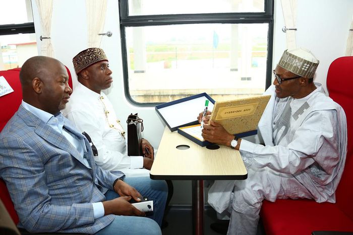 President Muhammadu Buhari takes a train ride with the Minister of Transport, Rotimi Amaechi and the Minsiter of state for Aviation, Hadi Sarika.
