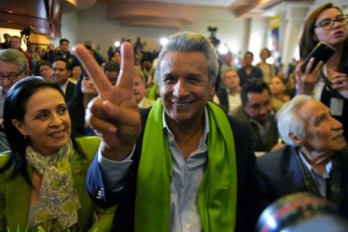 The Ecuadorean presidential candidate of the ruling Alianza PAIS party, Lenin Moreno, next to his wife Rocio Gonzalez (L), listens to the first results of the runoff election, in Quito on April 2, 2017
