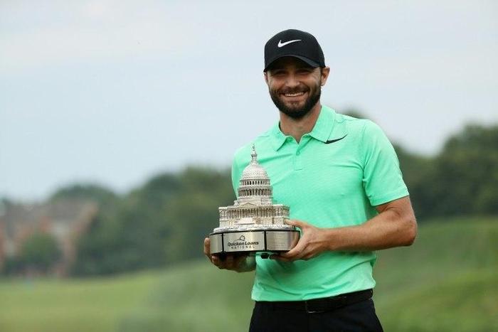 Kyle Stanley of the US celebrates with the winner's trophy after defeating compatriot Charles Howell in a playoff of the PGA National, in Potomac, Maryland, on July 2, 2017