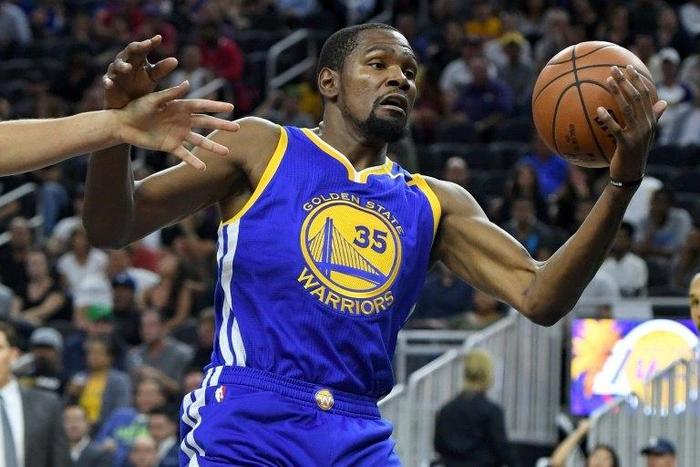 Kevin Durant of the Golden State Warriors grabs a rebound against the Los Angeles Lakers during their pre-season game at T-Mobile Arena in Las Vegas, Nevada, on October 15, 2016
